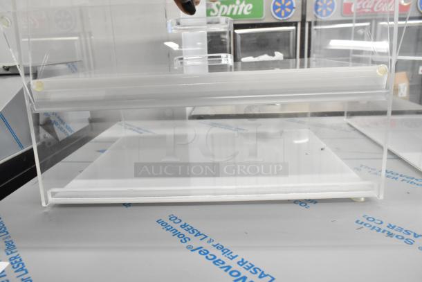 Clear poly countertop dry display case merchandiser, new condition, featuring multiple shelves and transparent design.
