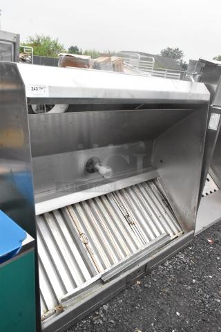 5' stainless steel grease hood with filters and light, in good condition. Visible tags indicate auction lot number.