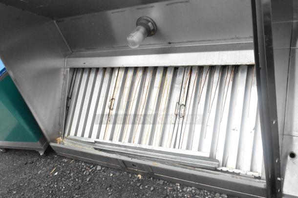 5' stainless steel grease hood with filters and light, showing signs of wear, ideal for commercial kitchens.