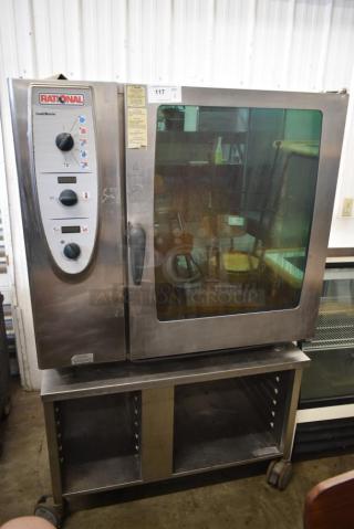 Rational stainless steel commercial gas combi convection oven on stand, control dials, glass door, tag with item number 117.