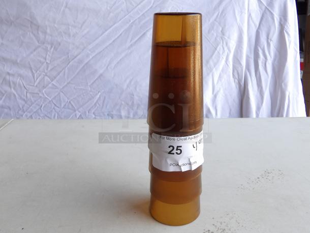 Four gold-toned plastic glasses, each 16 oz. Stacked, good condition, labeled "PCIAuctions.com" with auction info.