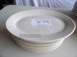 Set of 10 ivory stoneware platters, 12 1/2" x 8 7/8", wide rim, rolled edge. Some signs of use. Auction label reads "31, 10 QTY."