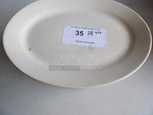 Ivory stoneware platter, 12.5"x8.875", wide rim, rolled edge. Slight wear visible, auction tag "35 14 QTY".