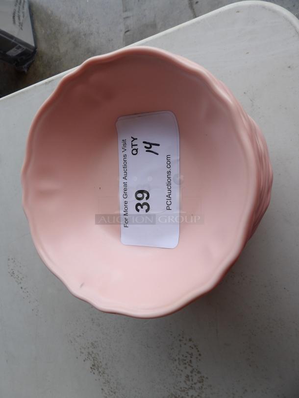 Pink ceramic bowl with a wavy rim, part of a set of 14. Auction label indicates "QTY 14, Item 39, PCIauctions.com."