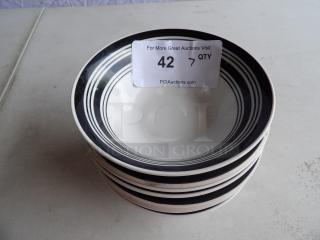 Seven black and white bowls, stackable, with clean condition. Auction lot number 42 visible on tag.