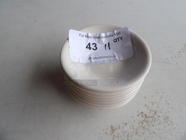 11 small white bowls stacked, auction label "43, 11 QTY" on top, each bowl in excellent condition.