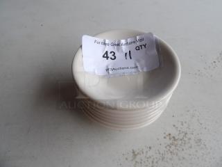 11 small white bowls stacked, auction label "43, 11 QTY" on top, each bowl in excellent condition.