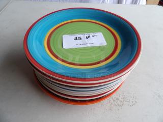 Set of 12 colorful plates with concentric designs, in good condition. Each plate features vibrant blues, greens, and reds.
