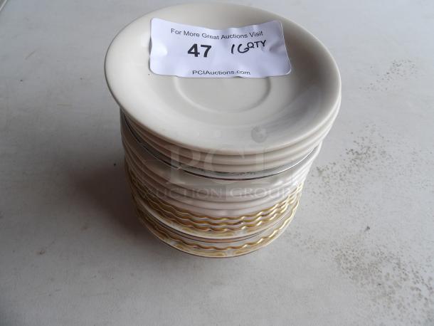 Stack of 16 bright white embossed 6" porcelain saucers, in good condition. Auction label shows "47" and "16 QTY."