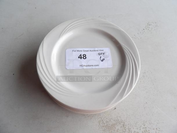 Set of 6 smaller than average white plates with subtle swirl design, labeled "Qty 6". Good condition.