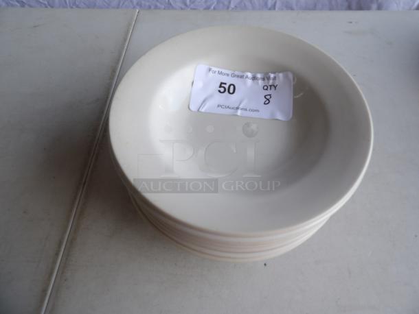 8 bright white stoneware soup bowls, 10 oz. each, wide rim, rolled edge. Condition: good. Label shows quantity 8.