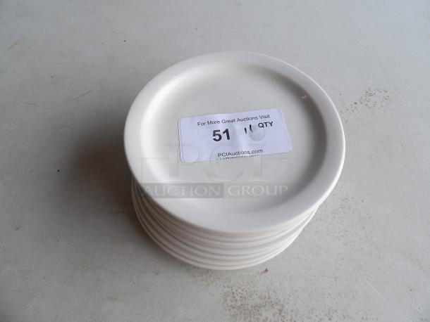 8 1/4" white stoneware plates, wide rim, rolled edge, set of 11, stacked. Sticker indicates auction item number 51.