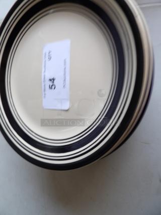 Set of 9 black, white, and blue plates with striped design, 9 inches each. Excellent condition. Auction label "54 GRY".
