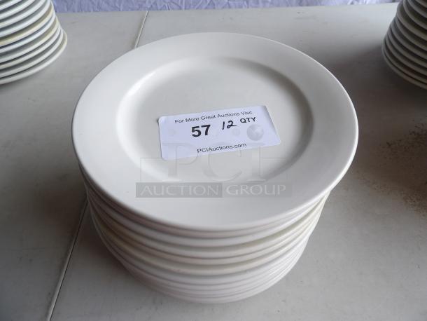9" bright white stoneware plates, wide rim, rolled edge, stack of 12. Label indicates quantity 12, PCI Auctions.