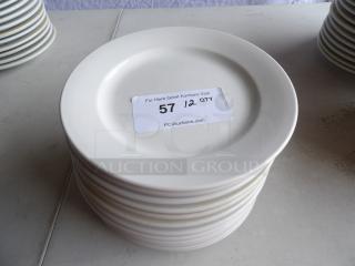 9" bright white stoneware plates, wide rim, rolled edge, stack of 12. Label indicates quantity 12, PCI Auctions.