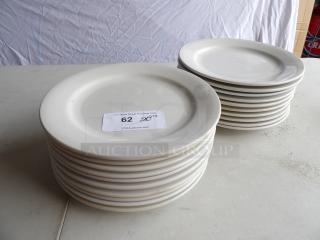 20 bright white 12" round stoneware plates in two stacks, in good condition, with auction lot number visible.