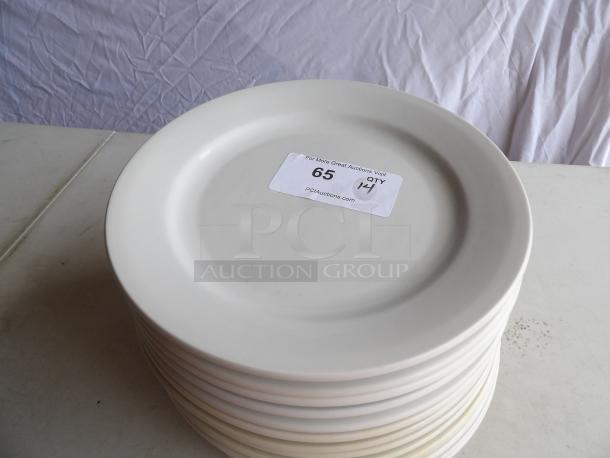 12" round bright white coupe stoneware plate, stack of 14, tag shows auction number 65, quantity 14, good condition.