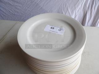 12" round bright white coupe stoneware plate, stack of 14, tag shows auction number 65, quantity 14, good condition.