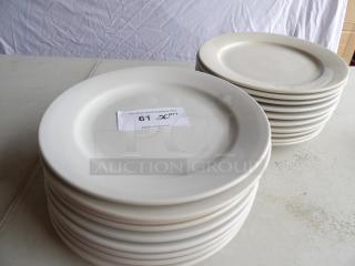 20 bright white stoneware plates, 12" round, in good condition. Auction tag shows "61 QTY" and "PCIAuctions.com."