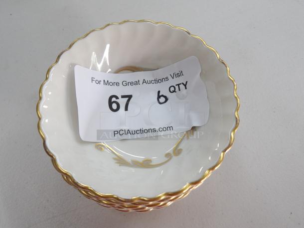 Small decorative dessert bowls with gold trim and floral design. Includes 6 bowls. Auction label indicates quantity 6.