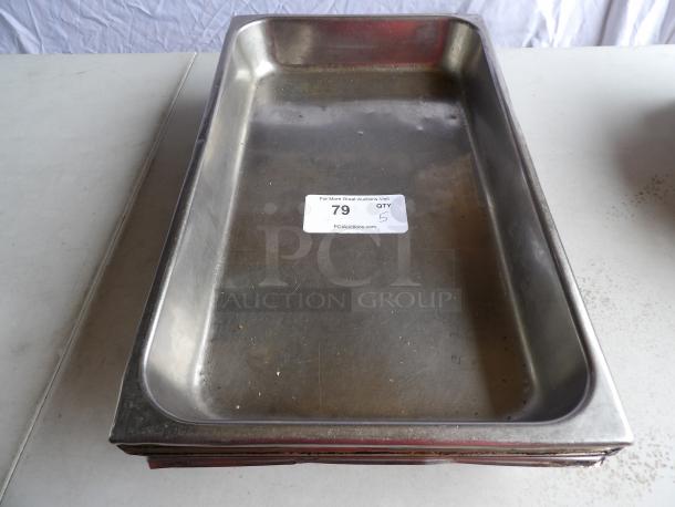 Five full-size 2 1/2" deep anti-jam 22 gauge stainless steel steam table pans, moderate wear, auction label visible.