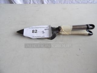 Triangular Pie Carver with steel blade and double handle, in good condition. Auction tag reads "82" and "2" from PCI Auctions.