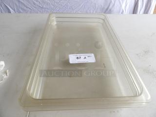 Full-size clear polycarbonate food pan, 2 1/2" deep, showing light wear. Auction tag reads "87, 2 QTY" from PCI Auctions.