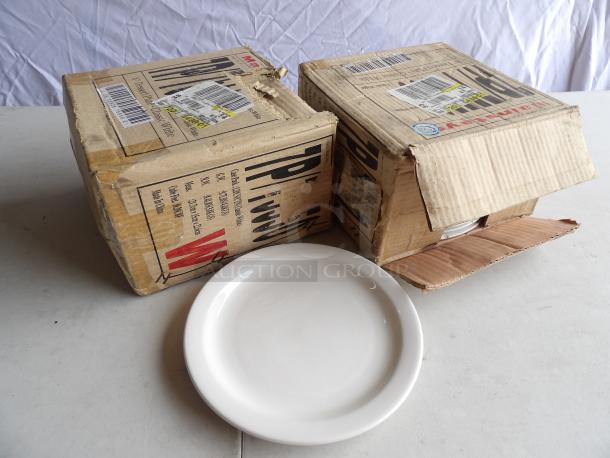 New in box 8" dessert plates by 24xBid, pristine condition with original packaging. Includes two boxes, each with visible barcodes and labels.