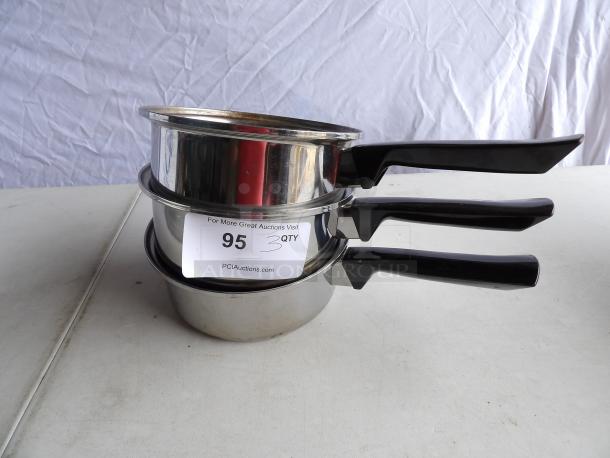 Three stainless steel sauce pans, 8" round x 3" deep, with black handles. Includes auction label stating "3 QTY".