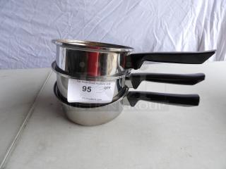 Three stainless steel sauce pans, 8" round x 3" deep, with black handles. Includes auction label stating "3 QTY".