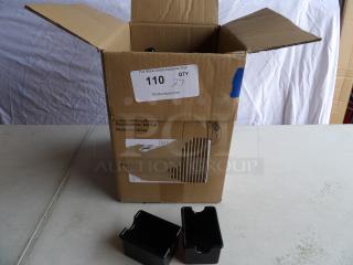 Cardboard box with open flaps, containing black plastic sugar packet holders. Box labeled "Made in China."
