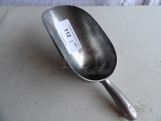 58 oz. aluminum scoop with ergonomic handle, showing moderate wear. Sticker with auction info on scoop.