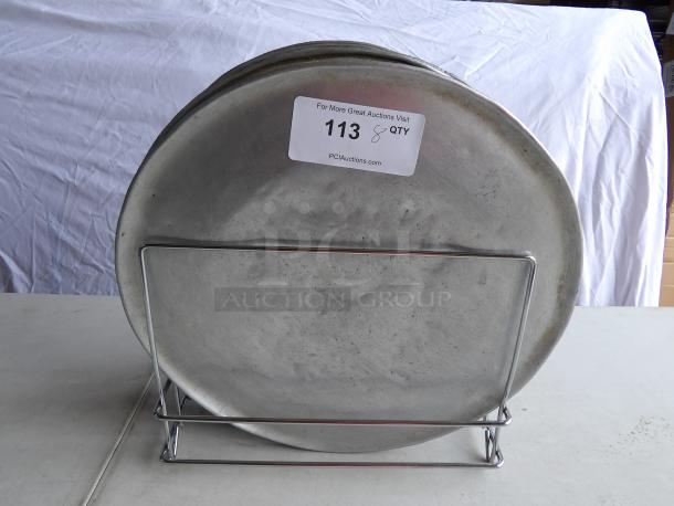 16" round aluminum pizza pans with rack, lightly used. Includes auction tag with quantity for 8.
