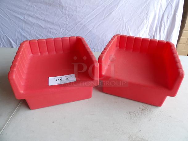Two red hard plastic booster seats with ribbed design, in good condition. Auction tag indicates quantity of two.