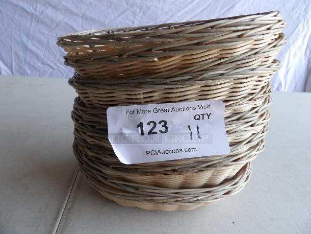 Stack of round wicker bread baskets with a label "123" and quantity "11," indicating auction details from PCI Auctions.