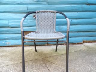 Like new black metal mesh patio arm chair with woven seat, sturdy frame, excellent condition, ideal for outdoor use.