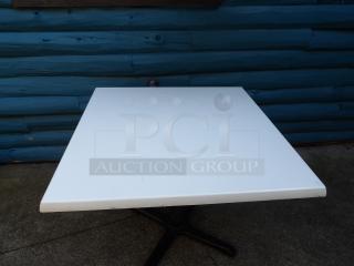 Outdoor dining table, heavy-duty composite top, approx. 36" square x 30", excellent condition, black pedestal base.