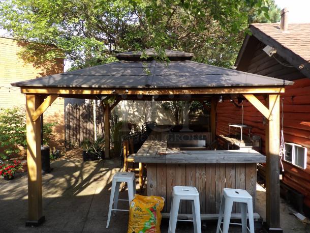 16Ft x 12Ft cedar outdoor gazebo with steel hardtop, wooden finish, like new condition. Buyer must dismantle.