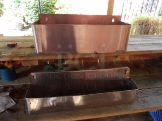 Two metal booze bottle holders on a wooden surface, showing slight wear. Ideal for storage or display. Sturdy with pre-drilled holes.