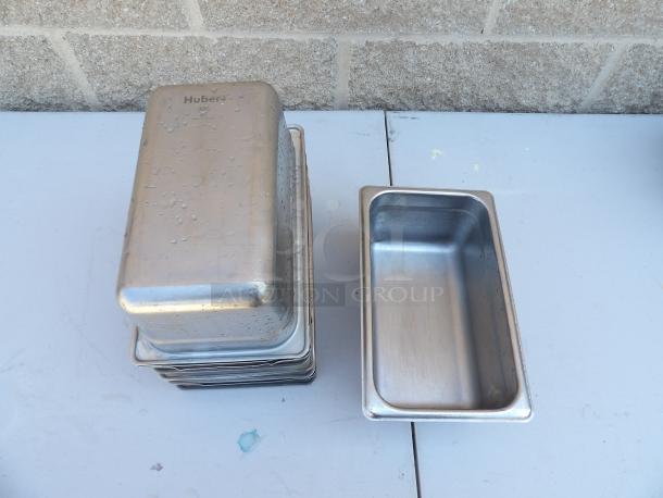 Huber stainless steel hotel pans, stack of 10, with visible branding and NSF label, used condition.