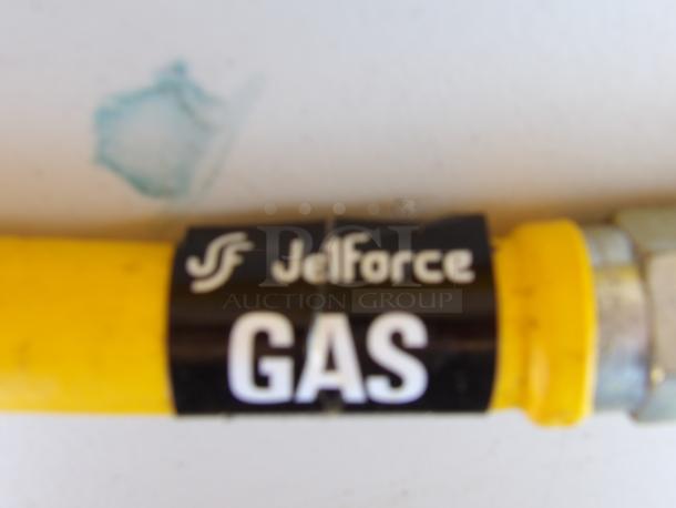Yellow 3/4" gas line with Jelforce branding. Black label reads "GAS." Condition is new with metal connector. Durable construction.
