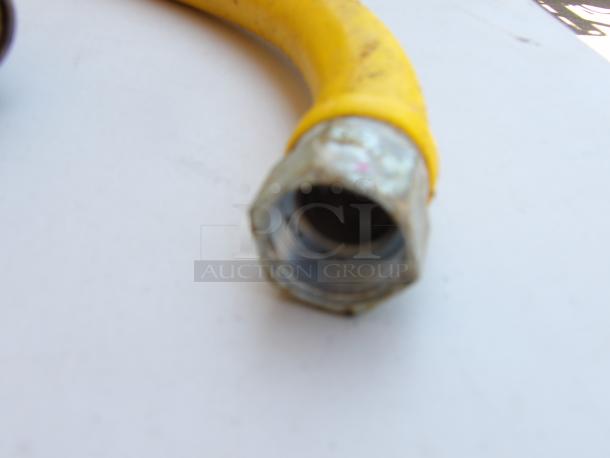 Quick Disconnect 32" x 3/4" gas line, featuring a yellow flexible hose with metal connectors, in used condition.