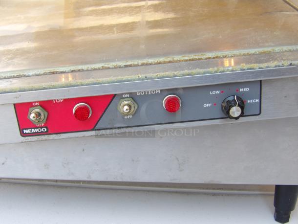 Nemco 6480-30S stainless steel heated display case with controls, showing wear. Features rear access, adjustable heat, and on legs.