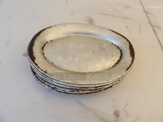 11 1/2" x 8" oval aluminum sizzler platter by 8xBid, features visible wear and patina, suitable for rustic decor.