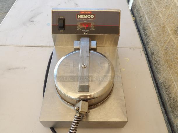 Nemco Waffle Maker Model 7030A, stainless steel, 120V, powers on. Visible on/off switch, digital timer display.