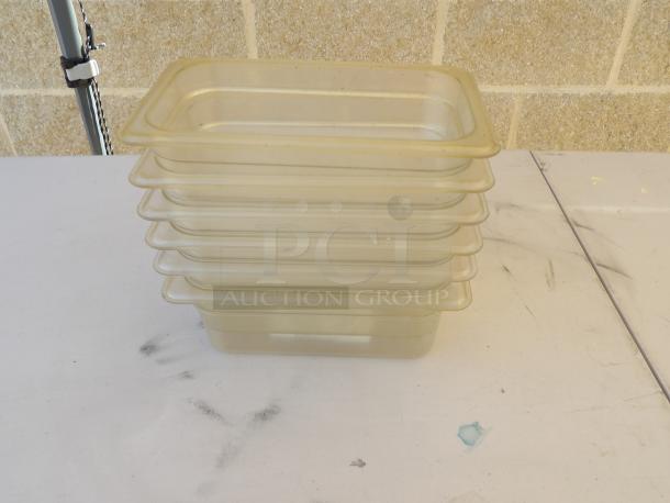 Set of six 1/4 size clear polycarbonate food pans, 2-3/4" deep, stacked. Used condition, suitable for food storage.