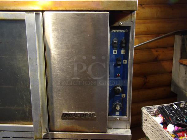 Imperial stainless steel commercial convection oven with view-through door, solid door, metal racks, and thermostatic controls.