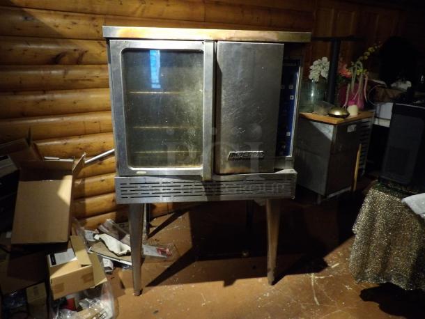 Imperial stainless steel commercial gas convection oven with view-through door, solid door, metal racks, thermostatic controls.