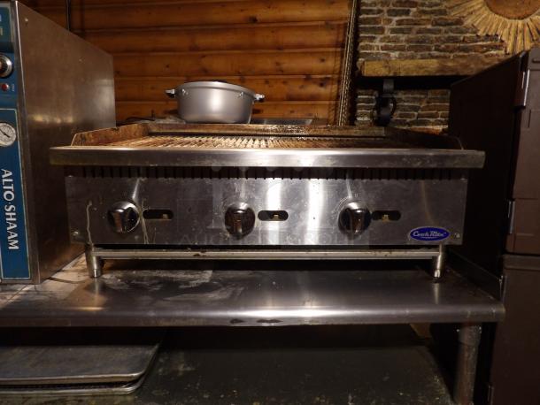 Cook Rite ATRC 36 stainless steel gas char broiler with back and side splashes, on legs; features three control knobs.