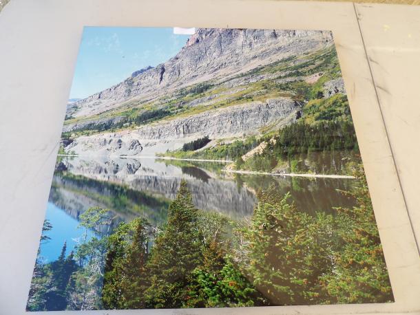 Landscape photograph of a mountain and lake, pristine condition, vibrant colors, showcasing natural reflection.